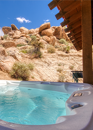 home exterior hot tub view of boulders hillside